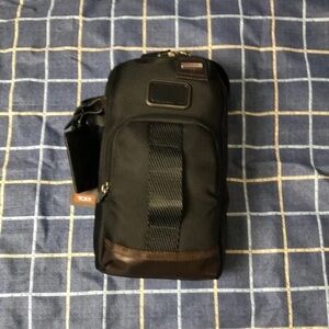 Tumi Black Chest Bag with Durable Fabric and Adjustable Strap